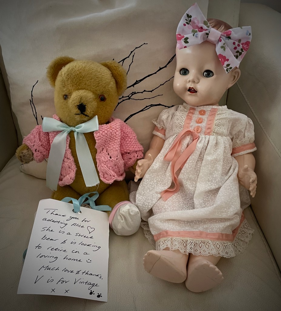 Alice the teddy bear adopted from V is  for Vintage. I redressed her for the exhibition into a suit of clothes knitted by my Mother around thirty five years ago. The Doll I re dressed in one of my childhood dolls dresses from the early 1950's.